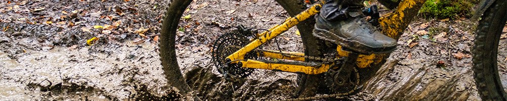 Specialized bike with contintental tyres riding through muddy water